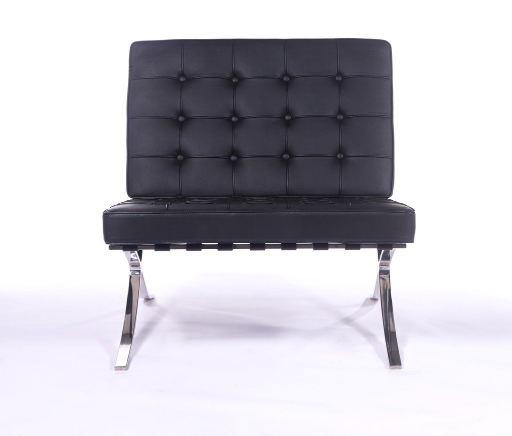 Close-up of the hand-tufted black leather on a Barcelona chair, buttoned squares and piping.