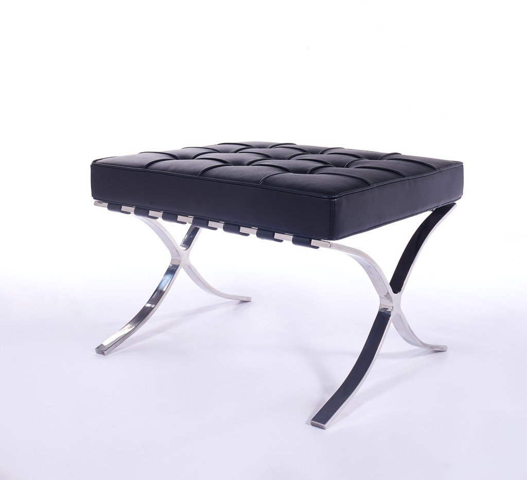 Matching black Barcelona ottoman with a single tufted leather cushion on a polished steel X-base.