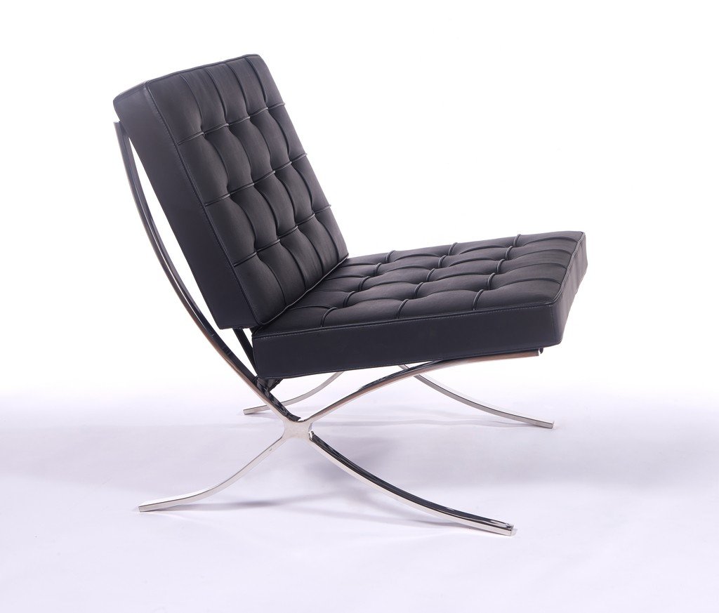 Black Barcelona style chair seen from the side, showing the cantilevered X-frame curve.