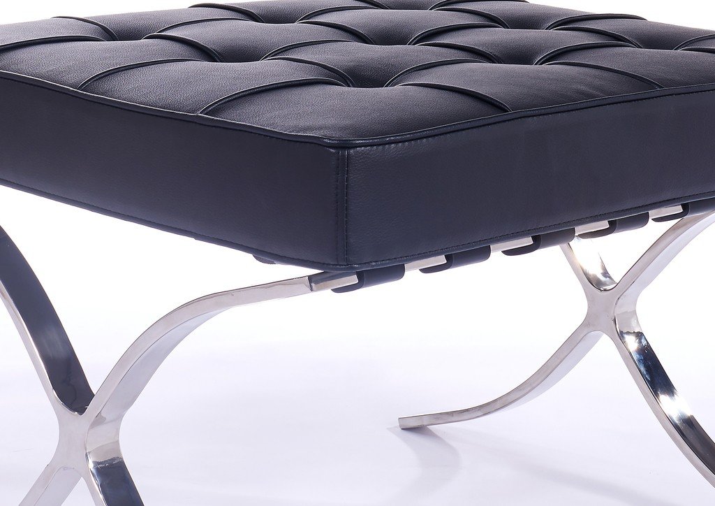 Close-up of the hand-tufted black leather on a Mies van der Rohe Barcelona chair, buttoned squares.