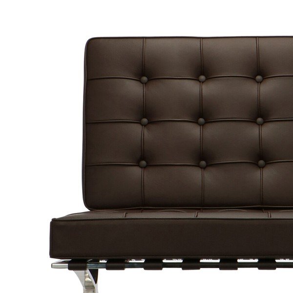 Close-up of the hand-tufted brown leather on a Barcelona chair, buttoned squares and piping.