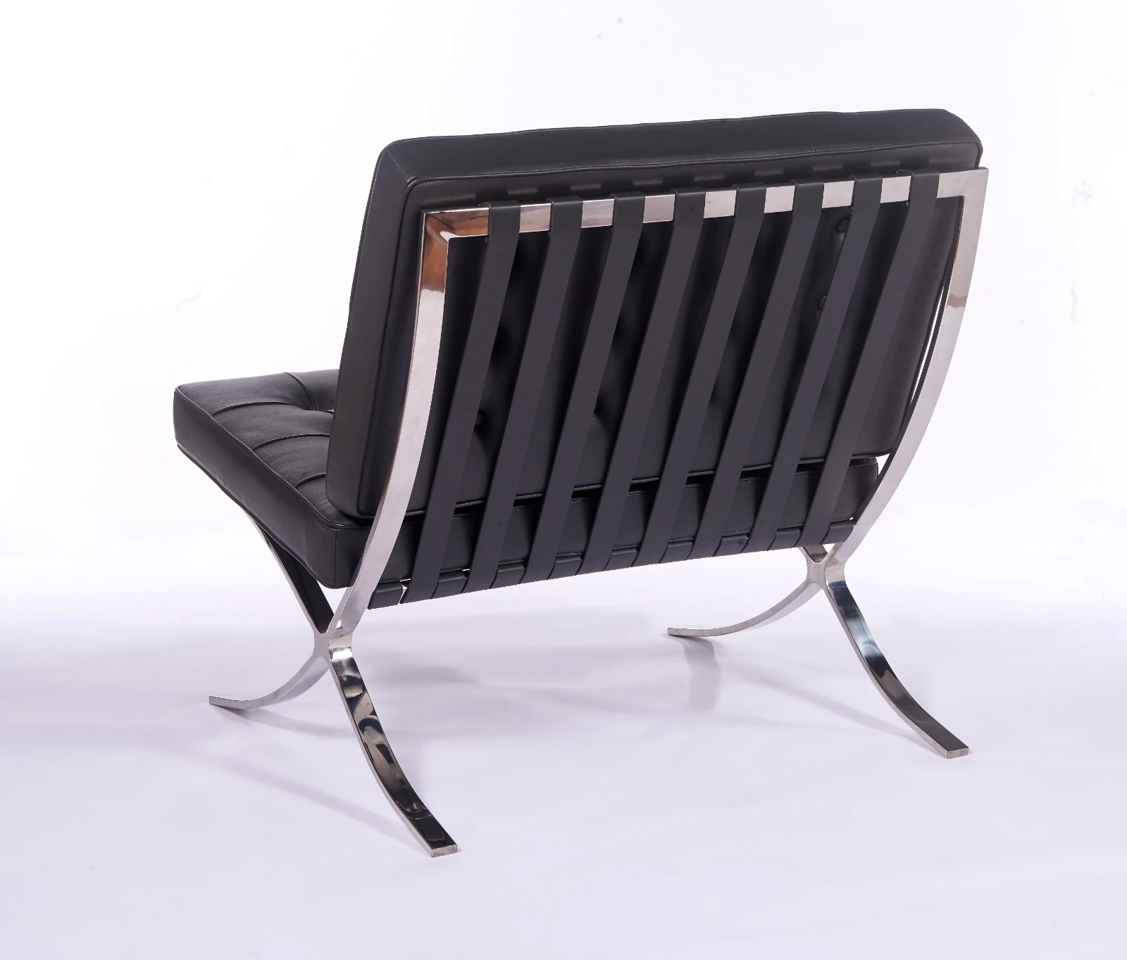Rear view of a dark grey Mies van der Rohe chair replica, single leather back panel on the X-frame.