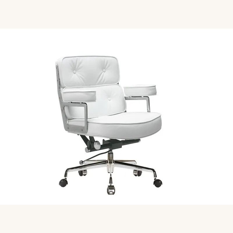 White Eames executive chair with three tufted leather cushions on a chrome base, front view.