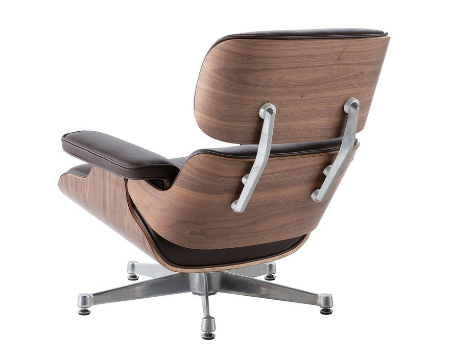 Walnut veneer shell of a chocolate brown Eames lounge chair beside the chrome frame, close grain.