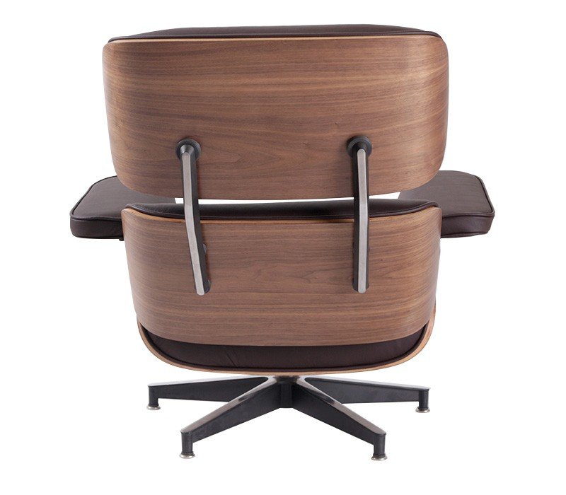 Chocolate brown Eames lounge chair on its own, deep brown leather on a walnut shell in a reading corner.