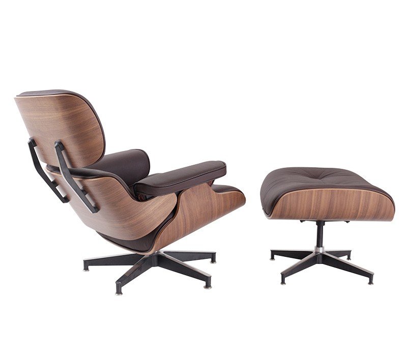 Dark brown Eames lounge chair seen from the side, walnut shell reclined on the aluminium base.