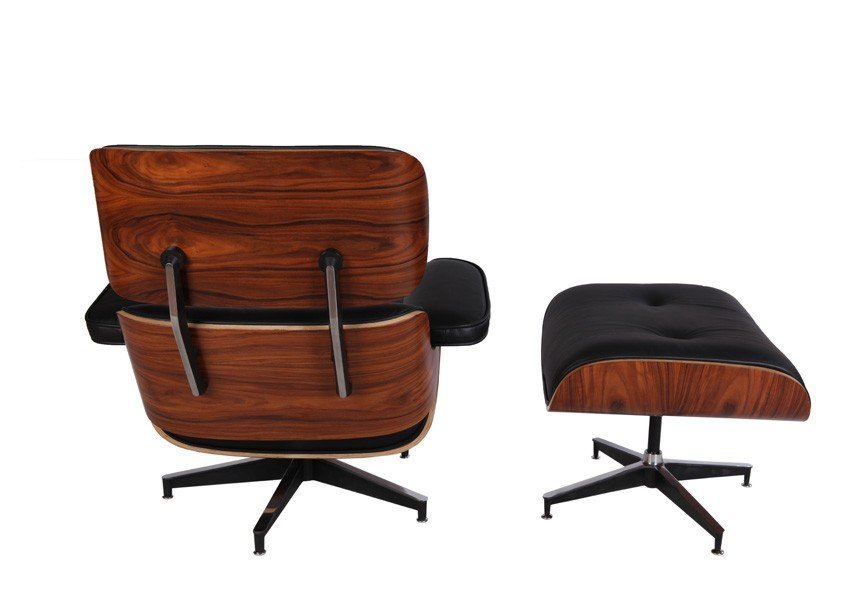 Eames lounge chair with a rosewood veneer shell and matching ottoman, black leather in a lounge. back view