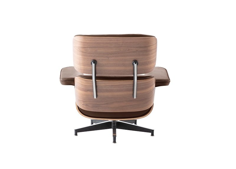 Polished aluminium base of an Eames lounge chair in tan leather and walnut, with 360-degree swivel.