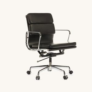 Black Eames office chair shown at an angle, soft-pad leather cushions on a chrome low-back frame.