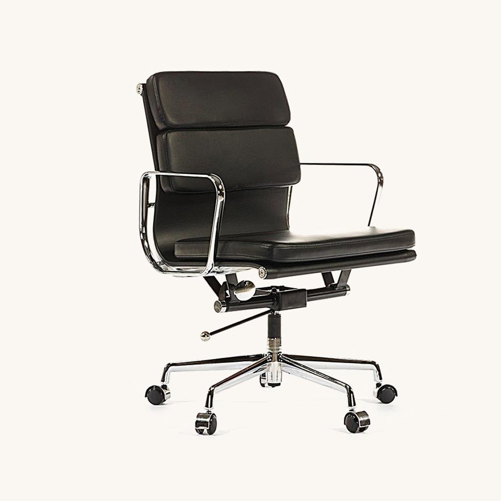 Black Eames office chair shown at an angle, soft-pad leather cushions on a chrome low-back frame.