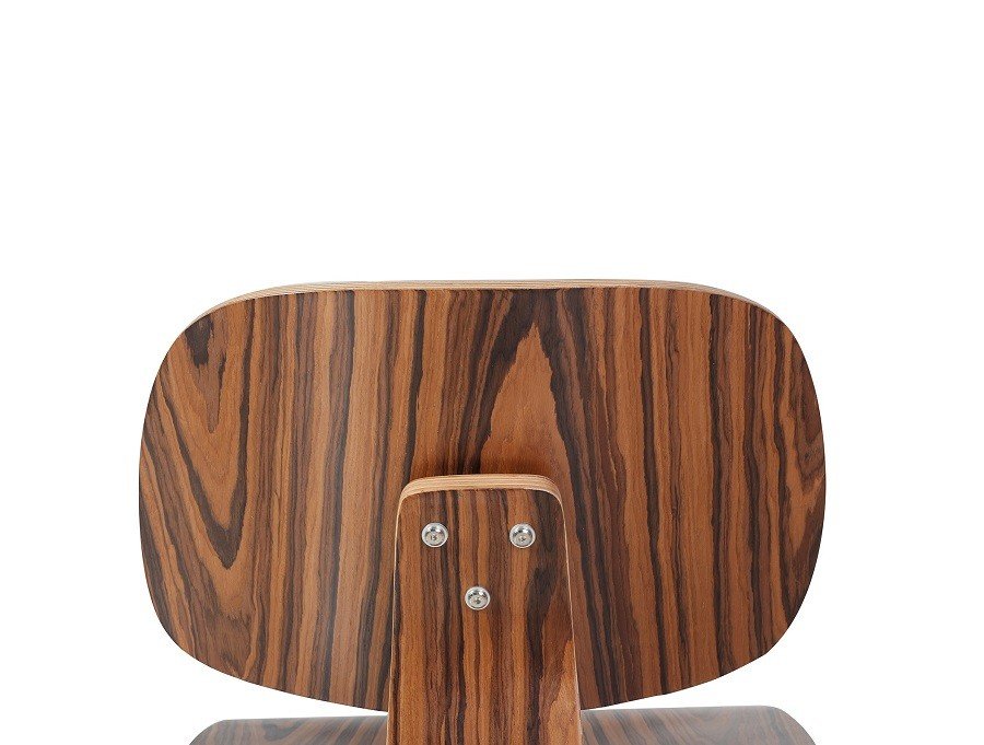 Curved plywood spine of an Eames plywood lounge chair replica in rosewood.