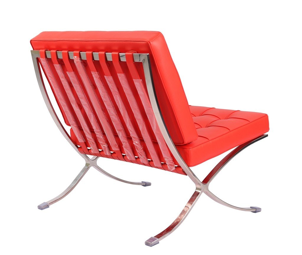 Red Barcelona chair and ottoman set at an angle, Mies van der Rohe and Lilly Reich design.