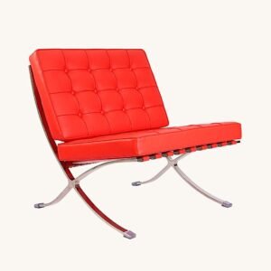 Red Barcelona chair with deep-buttoned leather tufting on a polished steel X-frame, front view.