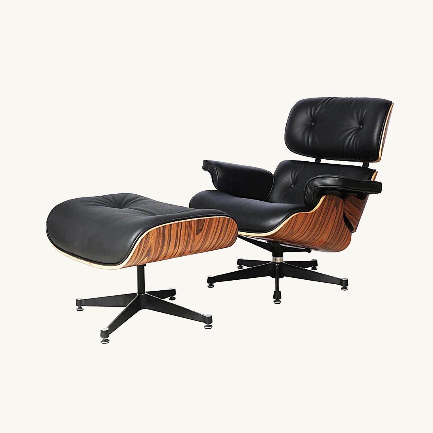 Eames lounge chair and ottoman in black leather with a rosewood shell on an elephant base, front view.